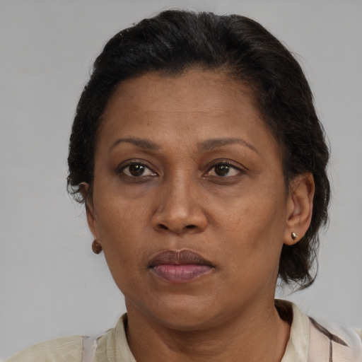 Joyful black adult female with short  brown hair and brown eyes