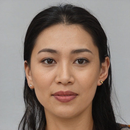 Joyful asian young-adult female with long  brown hair and brown eyes