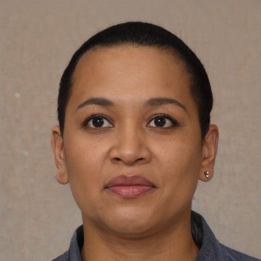 Joyful latino young-adult female with short  brown hair and brown eyes