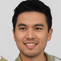 Joyful asian young-adult male with short  brown hair and brown eyes