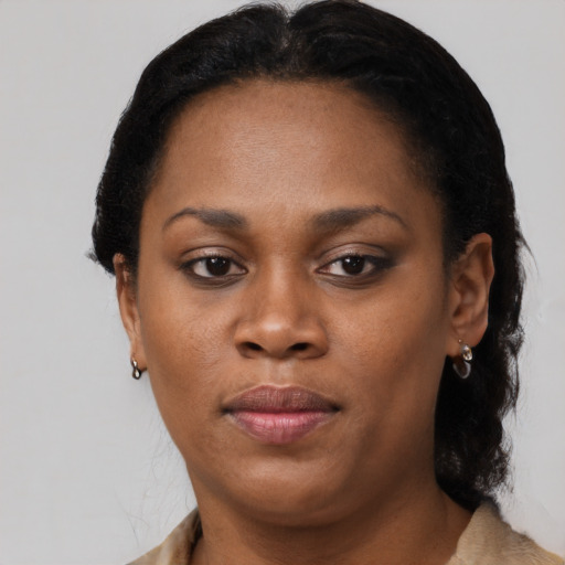 Joyful black adult female with short  brown hair and brown eyes