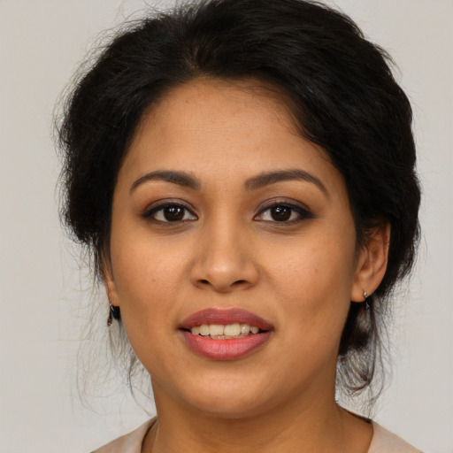 Joyful latino young-adult female with medium  brown hair and brown eyes