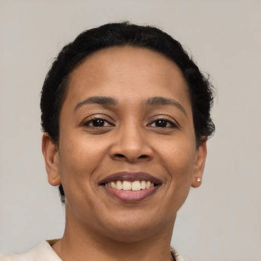 Joyful latino young-adult female with short  brown hair and brown eyes