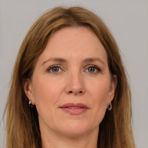 Joyful white adult female with long  brown hair and grey eyes