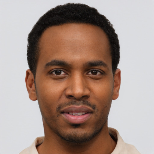 Joyful black young-adult male with short  black hair and brown eyes