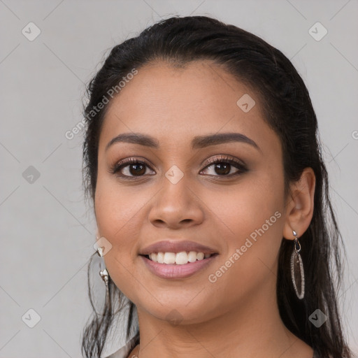 Joyful latino young-adult female with long  black hair and brown eyes