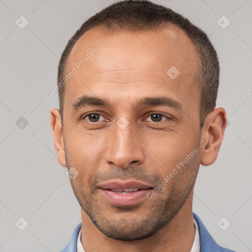 Joyful white young-adult male with short  brown hair and brown eyes