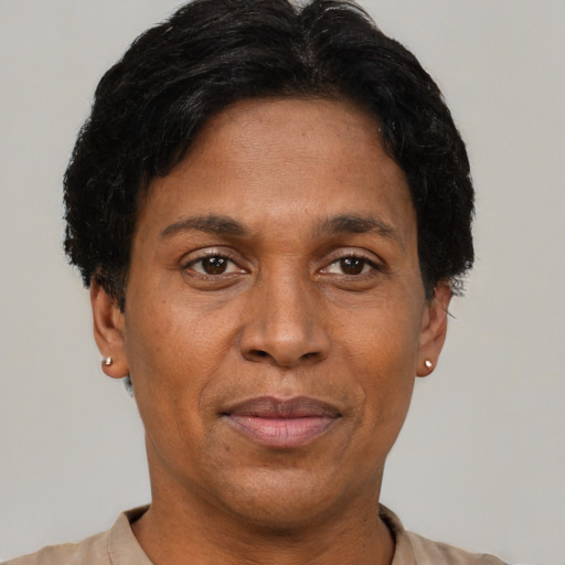Joyful black adult male with short  brown hair and brown eyes