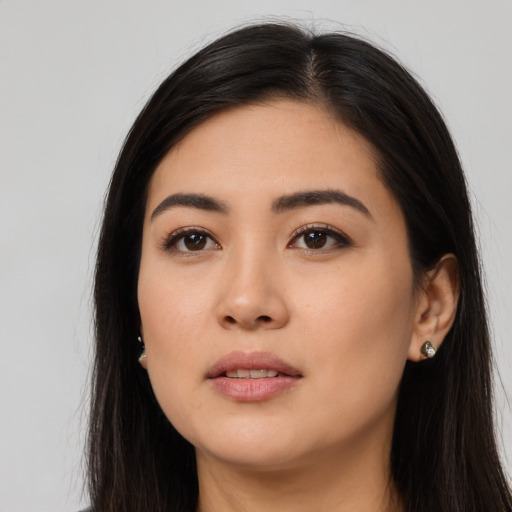 Joyful asian young-adult female with long  black hair and brown eyes