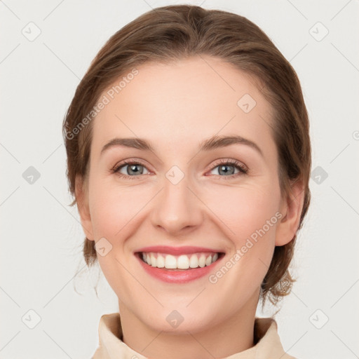 Joyful white young-adult female with medium  brown hair and grey eyes