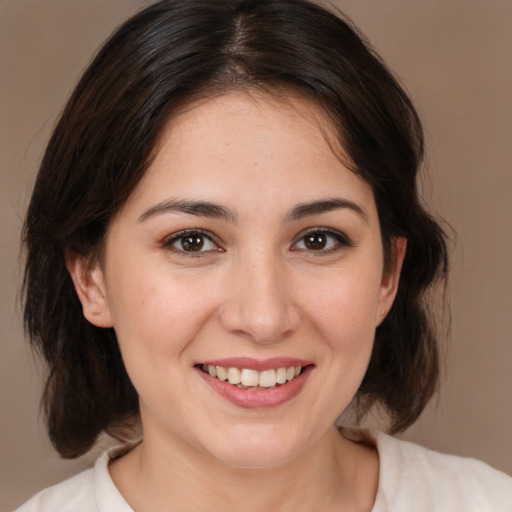 Joyful white young-adult female with medium  brown hair and brown eyes