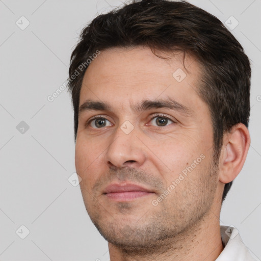 Joyful white adult male with short  brown hair and brown eyes