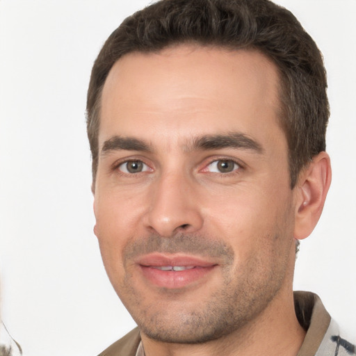 Joyful white young-adult male with short  brown hair and brown eyes