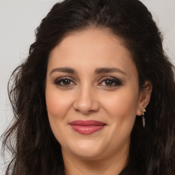 Joyful white adult female with long  brown hair and brown eyes