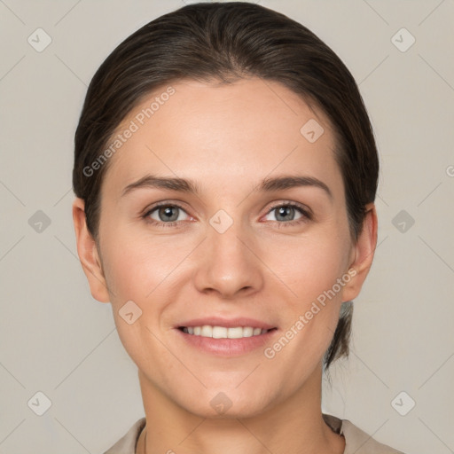 Joyful white young-adult female with short  brown hair and grey eyes