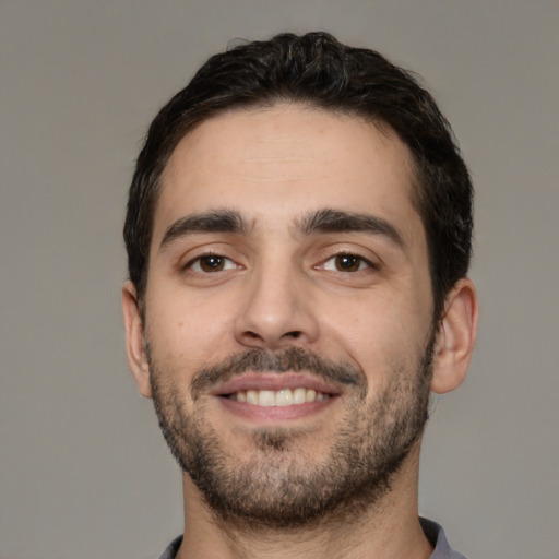 Joyful white young-adult male with short  black hair and brown eyes