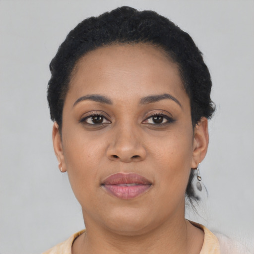 Joyful black adult female with short  black hair and brown eyes