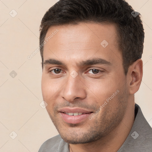 Joyful white young-adult male with short  brown hair and brown eyes