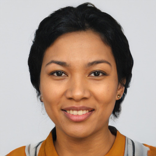 Joyful latino young-adult female with short  black hair and brown eyes