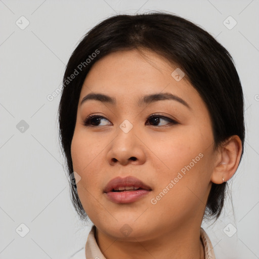 Joyful asian young-adult female with medium  black hair and brown eyes