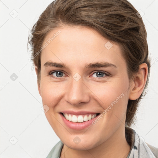 Joyful white young-adult female with medium  brown hair and grey eyes