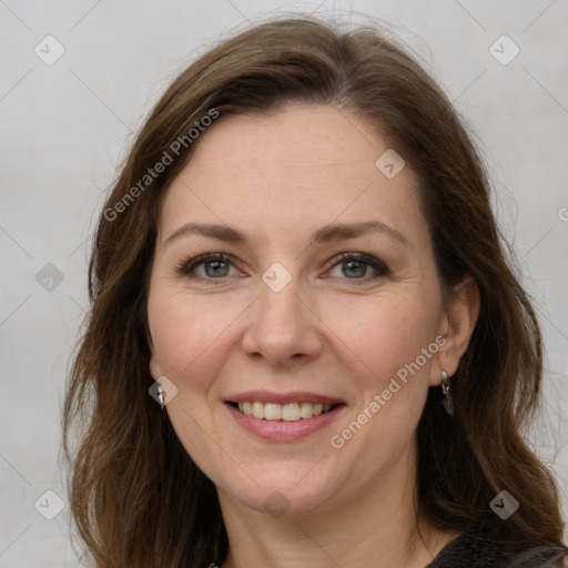 Joyful white adult female with medium  brown hair and grey eyes