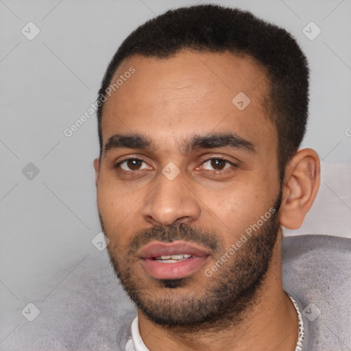 Joyful latino young-adult male with short  black hair and brown eyes