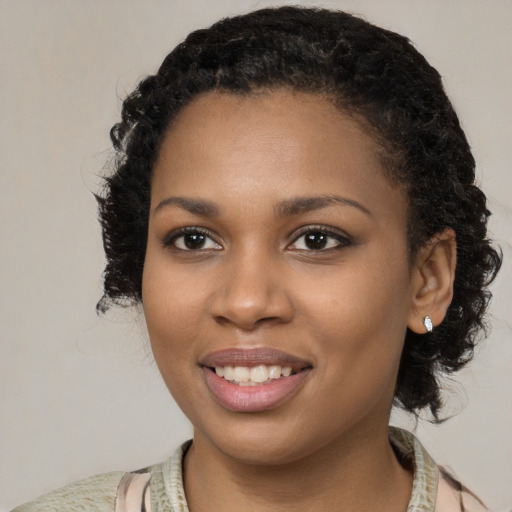 Joyful black young-adult female with medium  black hair and brown eyes
