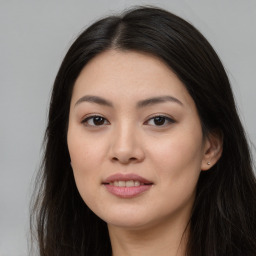 Joyful asian young-adult female with long  brown hair and brown eyes