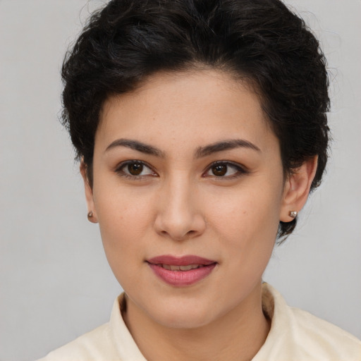 Joyful latino young-adult female with short  brown hair and brown eyes