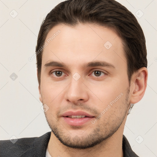 Joyful white young-adult male with short  brown hair and brown eyes