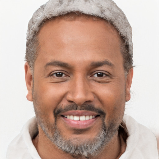 Joyful black adult male with short  brown hair and brown eyes