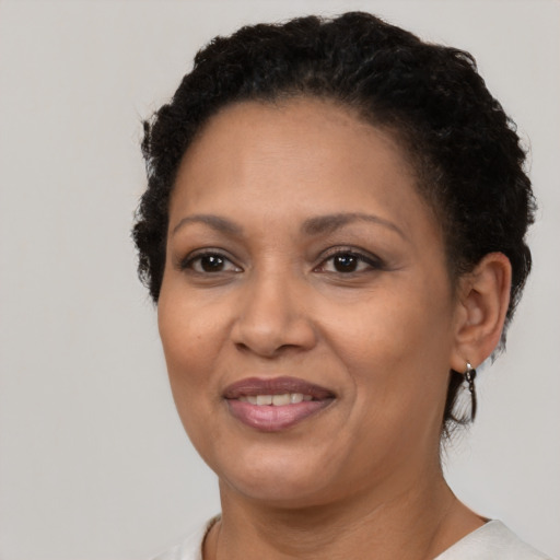 Joyful black adult female with short  brown hair and brown eyes
