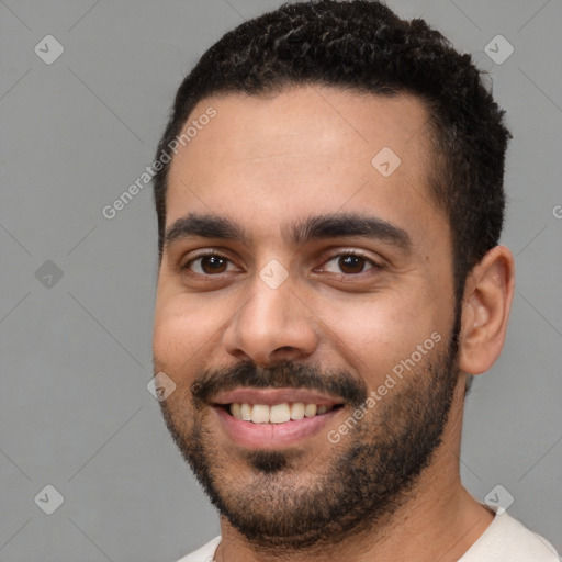 Joyful white young-adult male with short  black hair and brown eyes