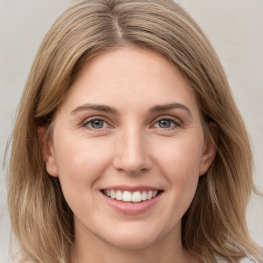 Joyful white young-adult female with long  brown hair and grey eyes