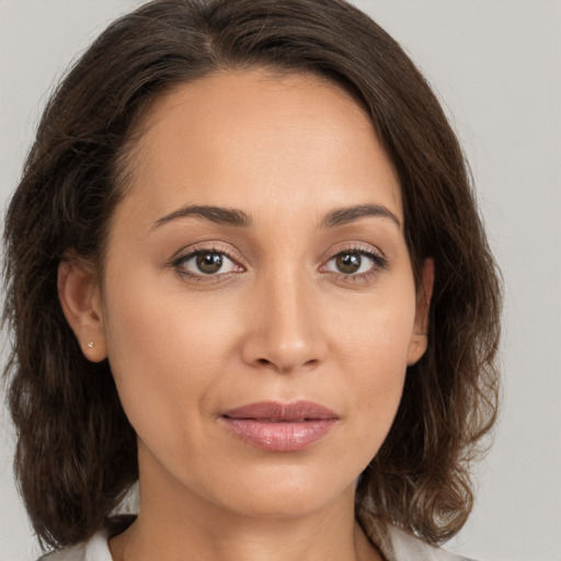 Joyful white young-adult female with medium  brown hair and brown eyes