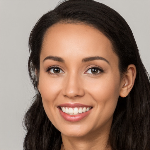 Joyful latino young-adult female with long  black hair and brown eyes