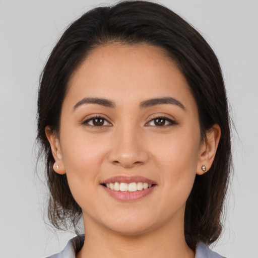 Joyful white young-adult female with medium  brown hair and brown eyes