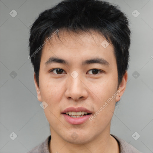 Joyful asian young-adult male with short  black hair and brown eyes