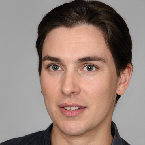 Joyful white young-adult male with medium  brown hair and brown eyes