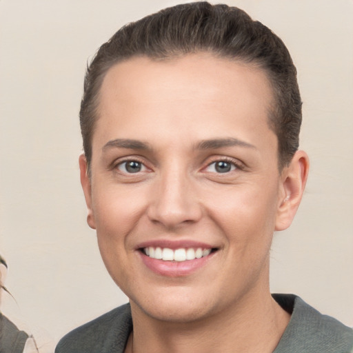 Joyful white young-adult female with short  brown hair and brown eyes