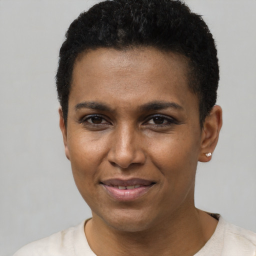 Joyful latino young-adult female with short  black hair and brown eyes