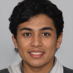 Joyful latino young-adult male with short  brown hair and brown eyes