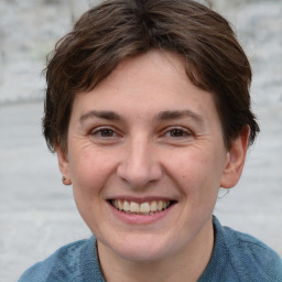 Joyful white adult female with short  brown hair and grey eyes