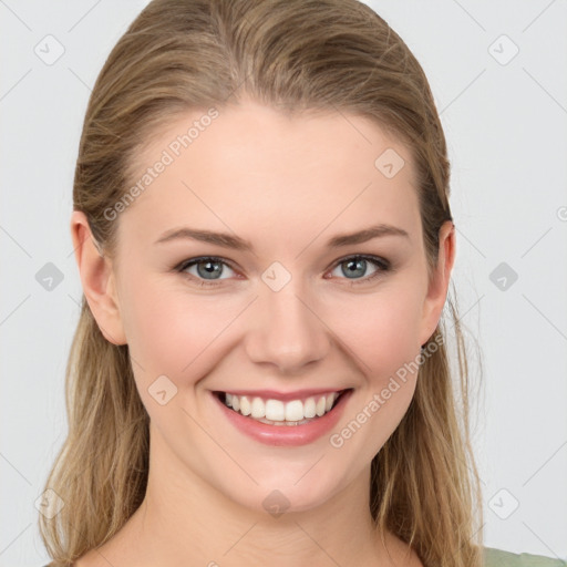 Joyful white young-adult female with long  brown hair and blue eyes