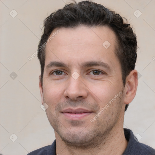 Joyful white young-adult male with short  black hair and brown eyes