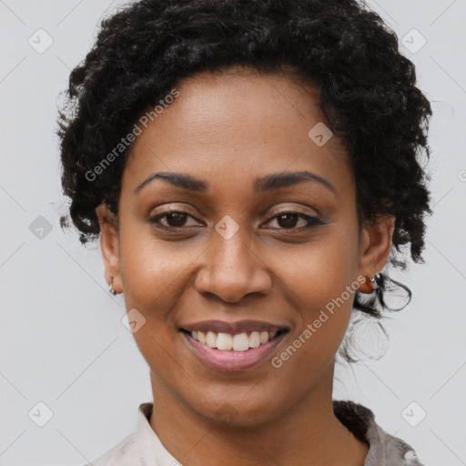 Joyful black young-adult female with short  black hair and brown eyes