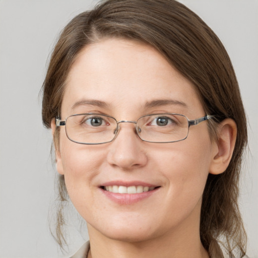 Joyful white young-adult female with medium  brown hair and grey eyes