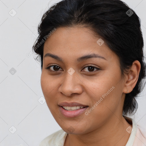 Joyful latino young-adult female with medium  brown hair and brown eyes