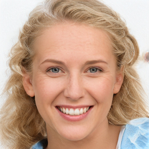 Joyful white young-adult female with long  brown hair and blue eyes